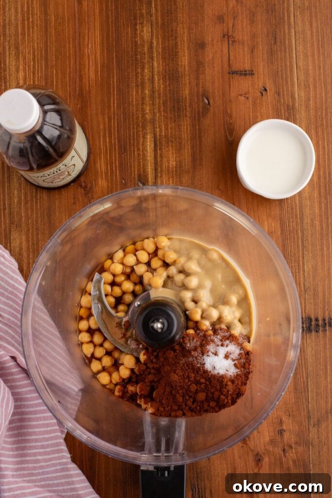 Decadent Chocolate Hummus 4 All chocolate hummus ingredients, excluding milk, placed in a food processor bowl, ready for blending.