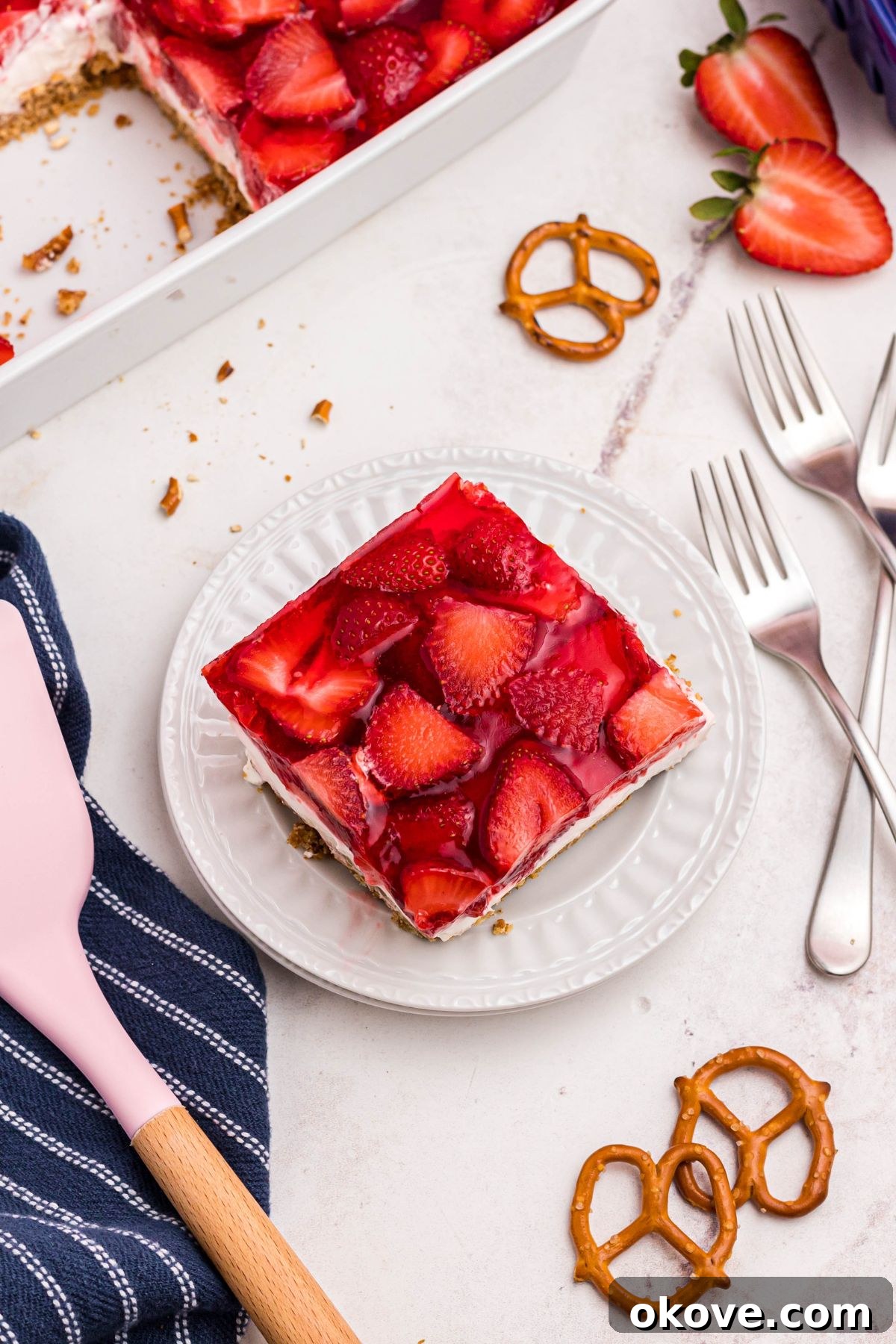 Strawberry Pretzel Dream 13 Slice of pretzel salad on small white plate with pink spatula next to plate.