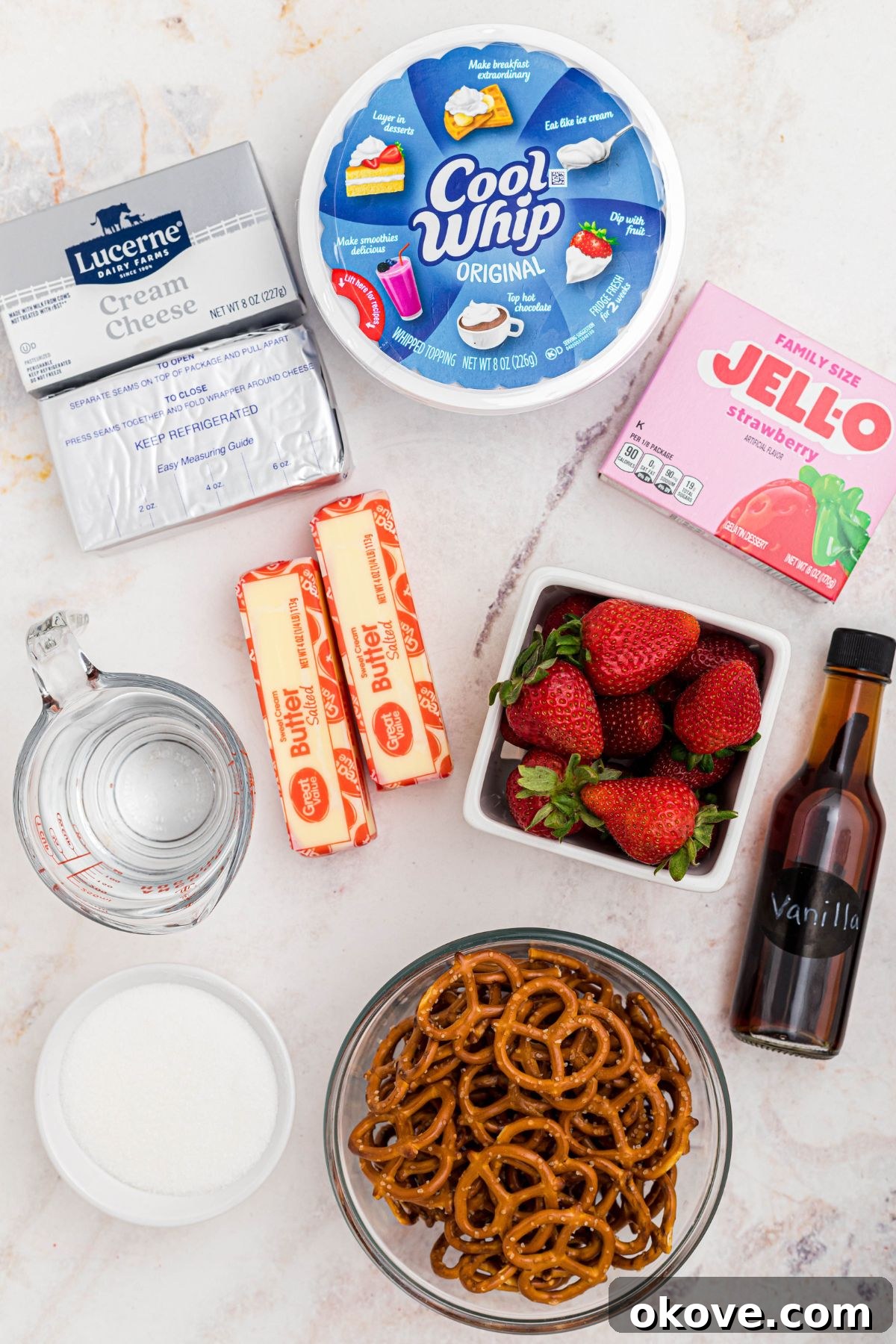 Strawberry Pretzel Dream 3 Ingredients needed to make strawberry pretzel salad measured in small bowls on a white marble table.