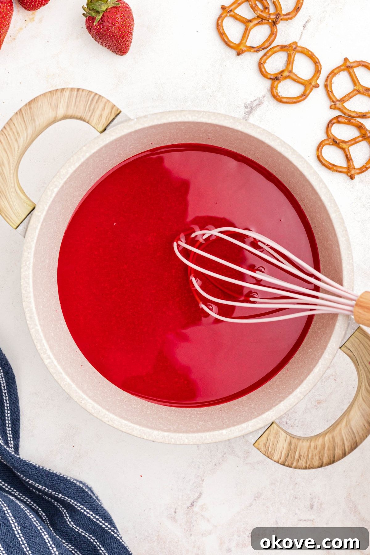 Strawberry Pretzel Dream 10 Strawberry Jell-o being mixed with boiling water in a saucepan.