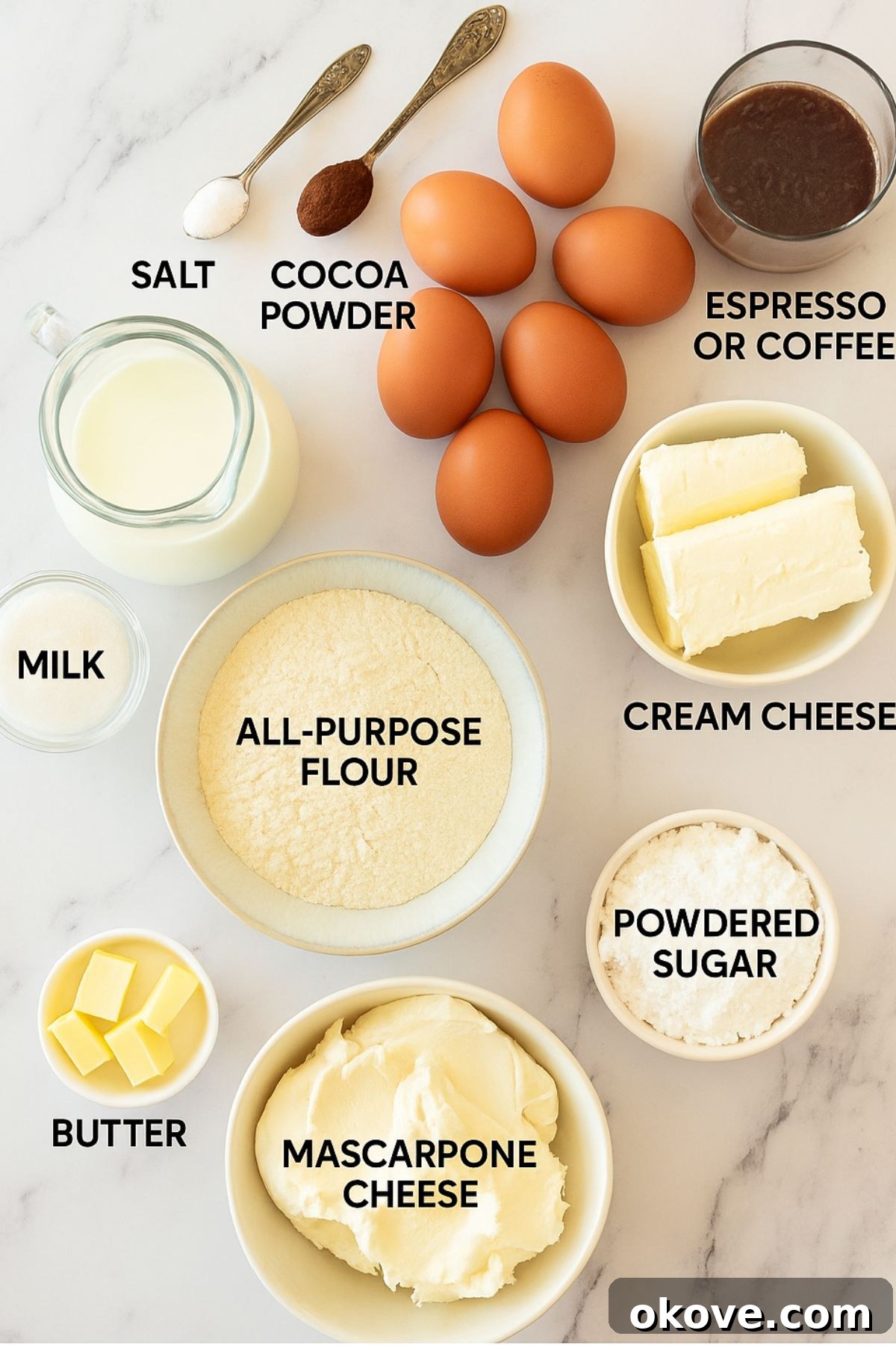 Stacked Crepe Dream 3 All the necessary ingredients to make a tiramisu crepe cake, meticulously measured into small dishes and arranged on a pristine white marble table, ready for preparation.