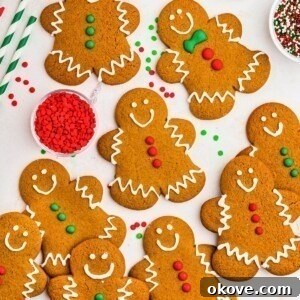 Golden brown gingerbread cookies frosted and scattered on a marble table.