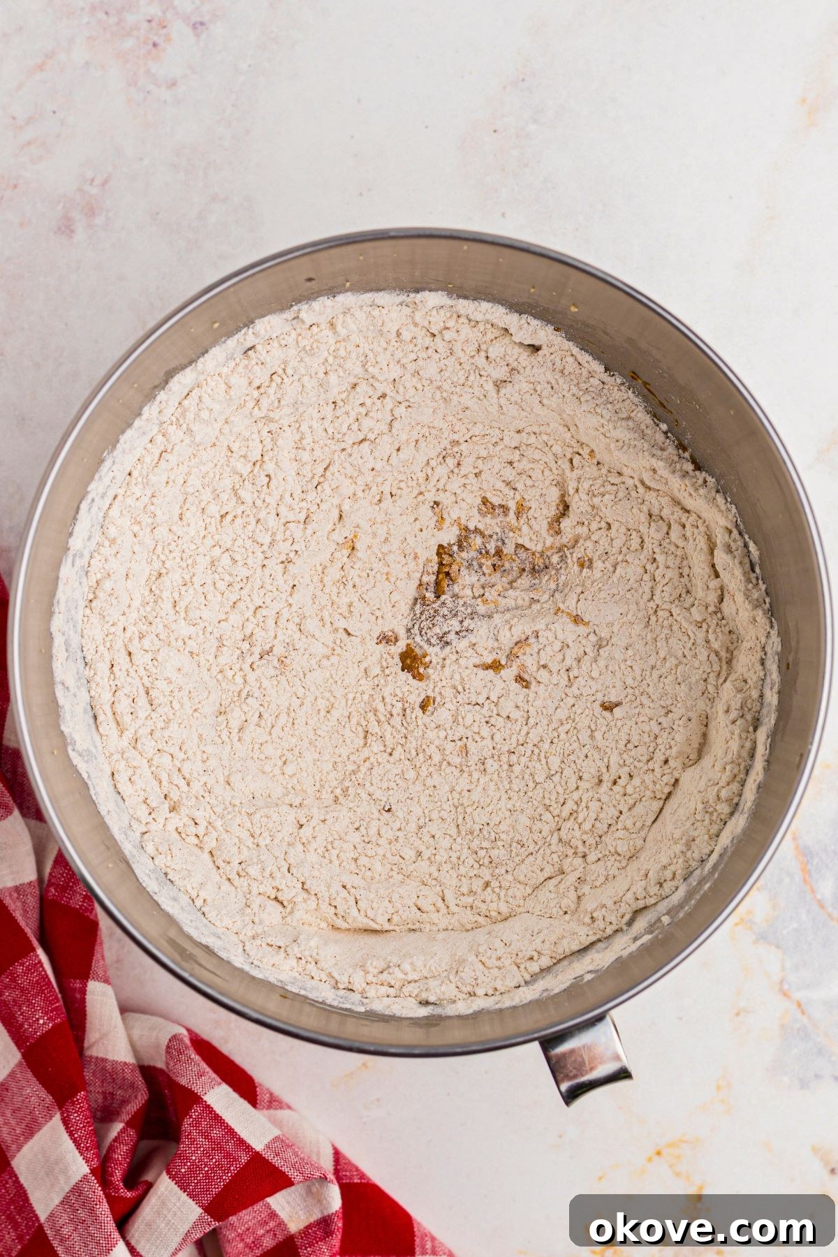 Festive Gingerbread Delights 4 Flour and other dry ingredients mixed together in a silver mixing bowl.