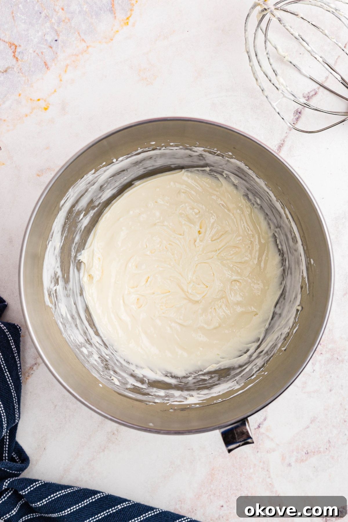 Sweet and Creamy Fruit Dip 5 The fruit dip, now perfectly smooth, creamy, and airy, rests in a large silver mixing bowl after being thoroughly blended, showcasing its inviting texture.
