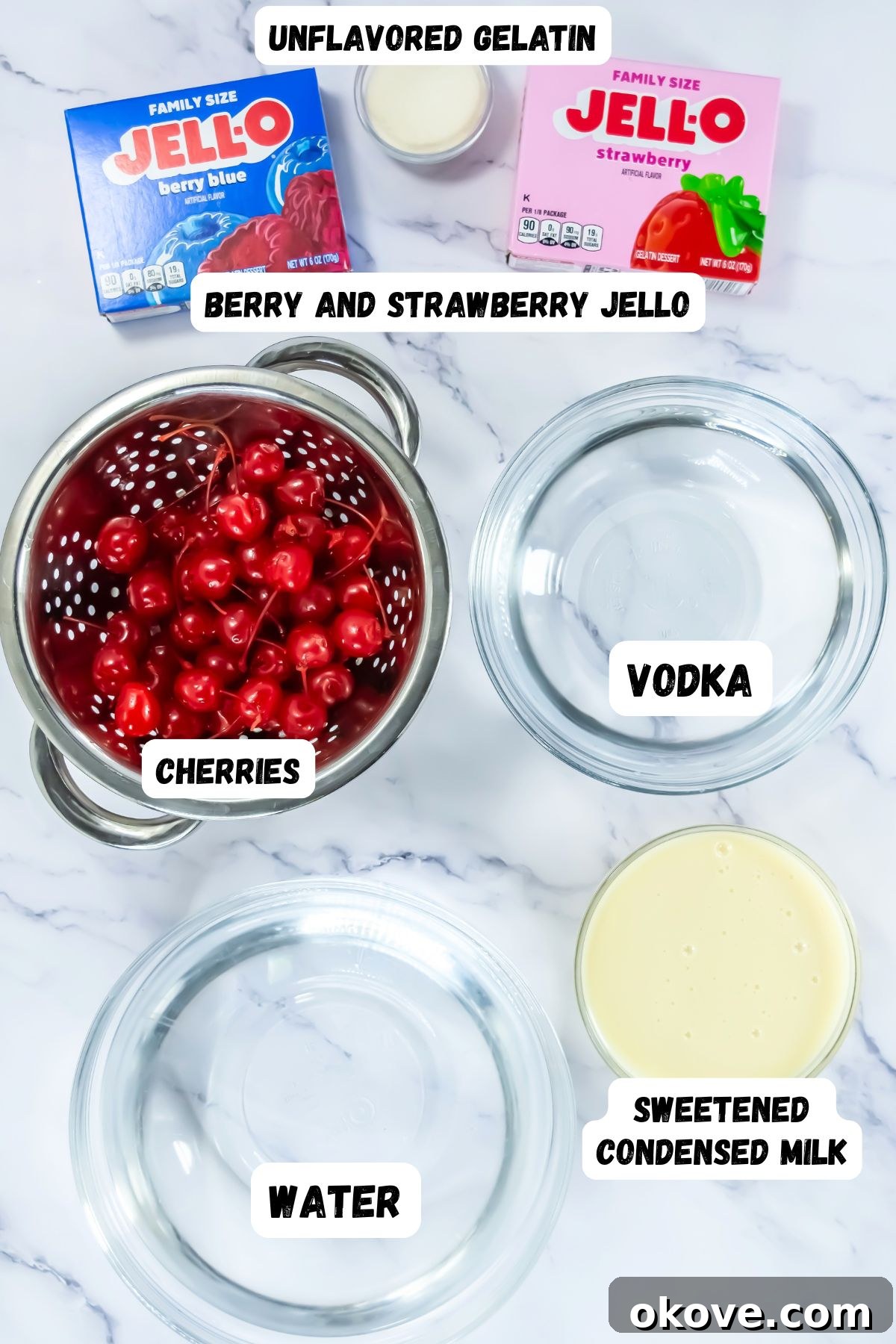 Tri-Color Celebration Shots 3 Assortment of Jello, vodka, water, and other ingredients laid out in glass bowls on a elegant marble table, ready for jello shot preparation.