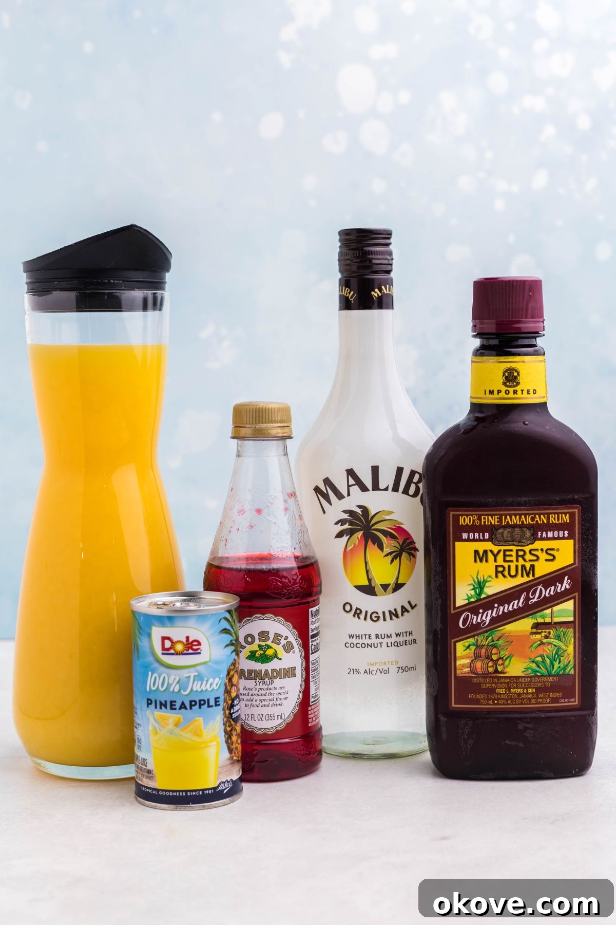 Bottles of alcohol and juices on a marble table. 