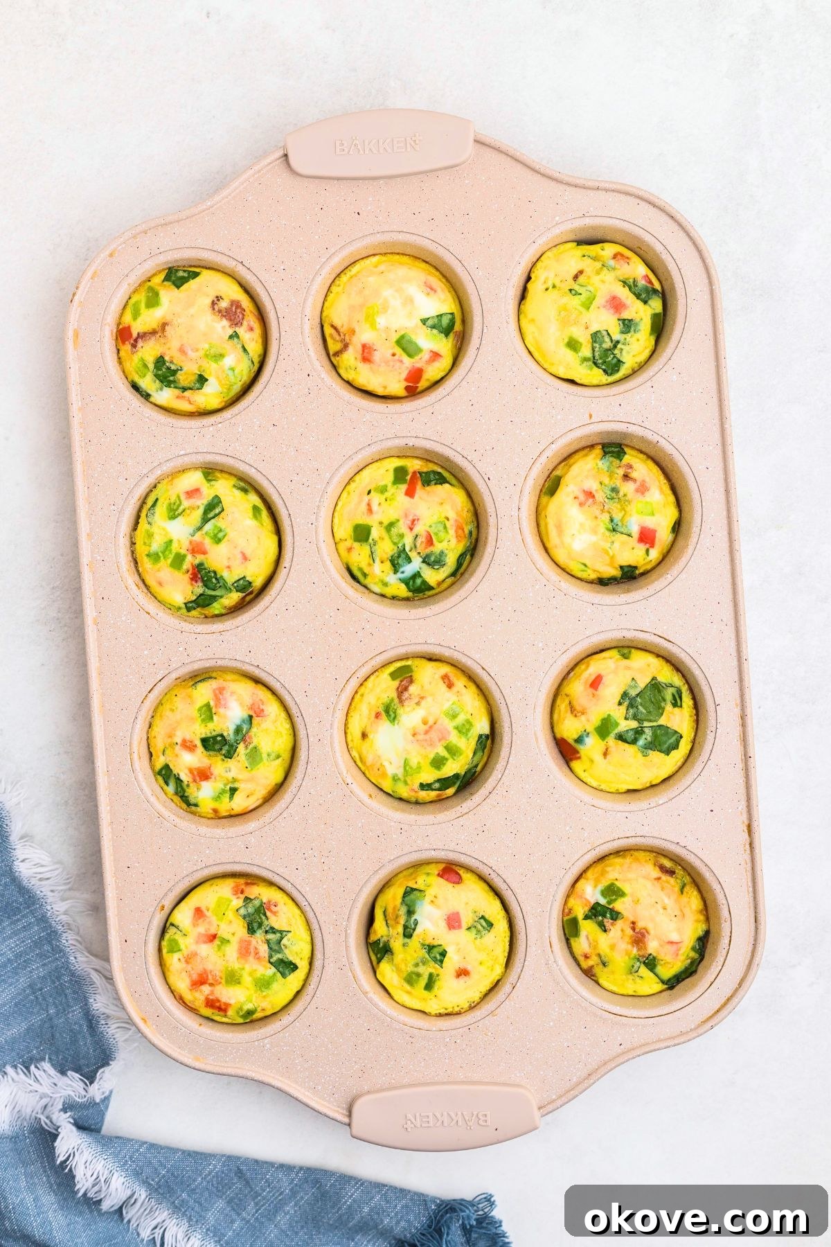 Freshly baked eggs bites in a muffin pan after baking in the oven.