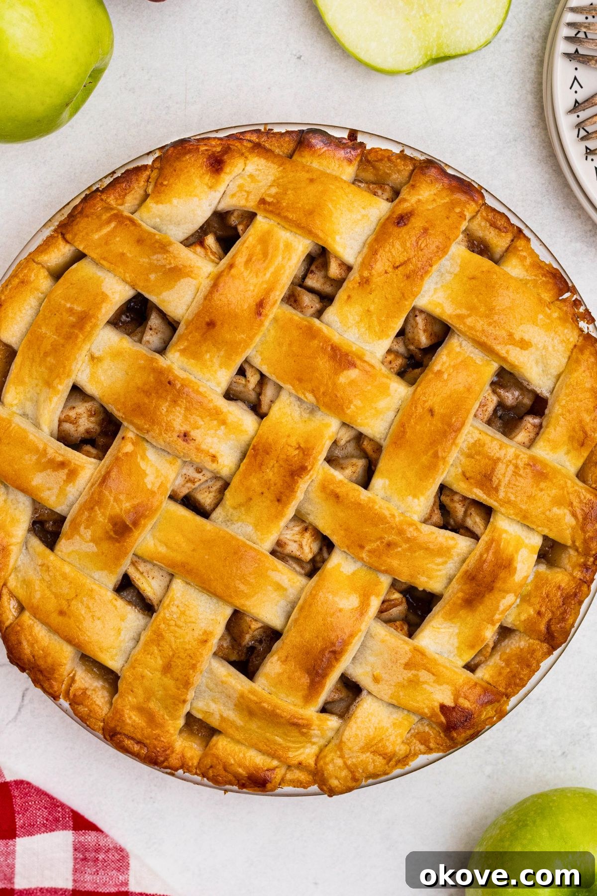 Golden baked apple pie on a white marble table. 