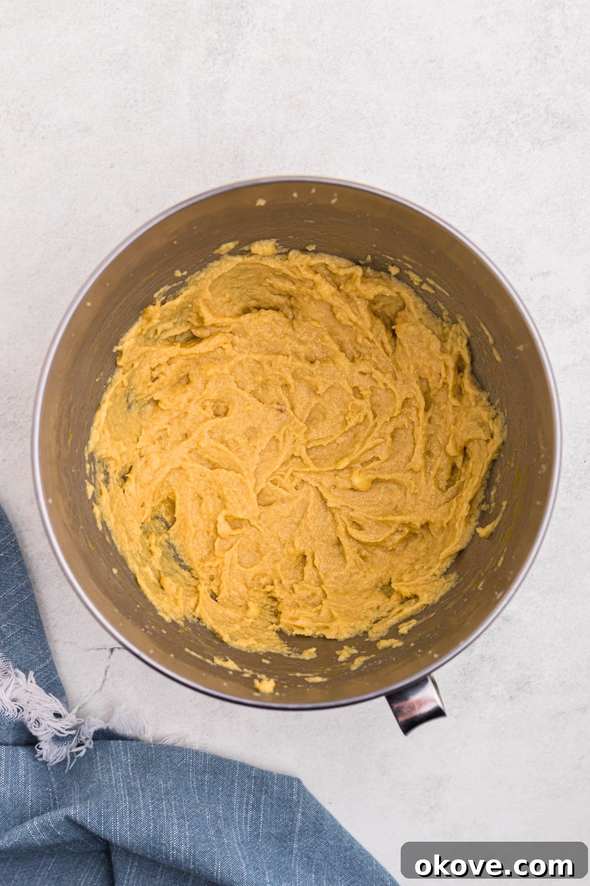 Ultimate Chocolate Chip Bars 5 Cookie dough mixed together in a silver bowl before adding the dry ingredients.