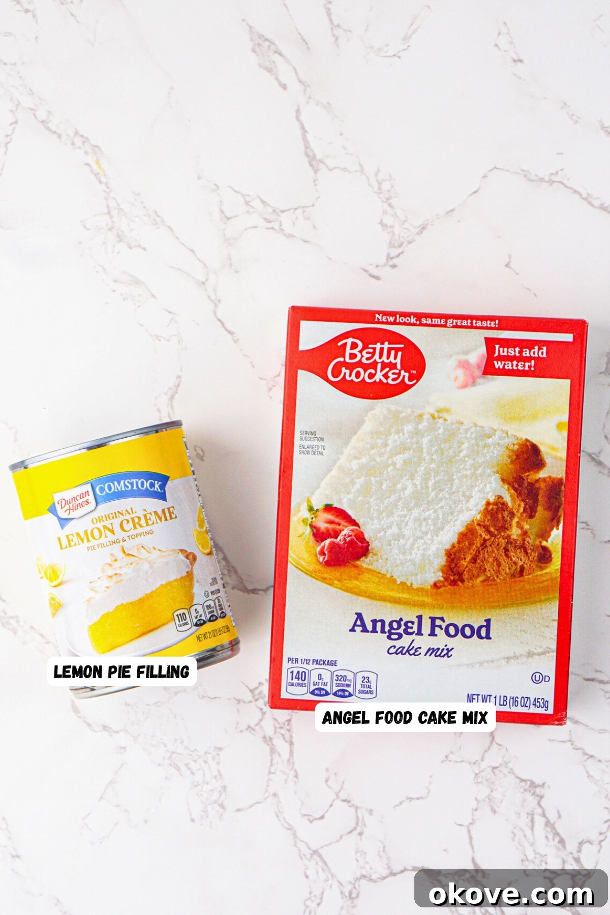 Effortless Two-Ingredient Lemon Bars 3 Box of angel food cake mix and can of lemon pie filling on a white marble table. The two main ingredients for easy lemon bars.