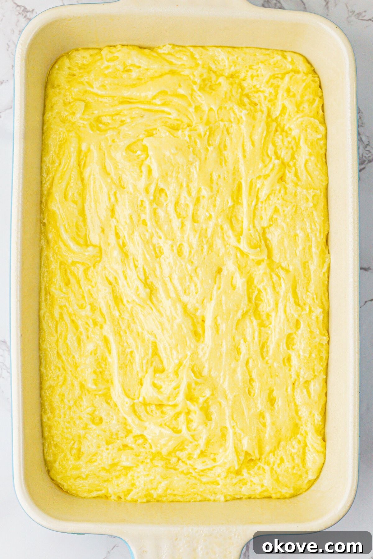Effortless Two-Ingredient Lemon Bars 5 9x13 baking dish with batter mixed and spread into dish. Ready to bake the easy lemon bars.
