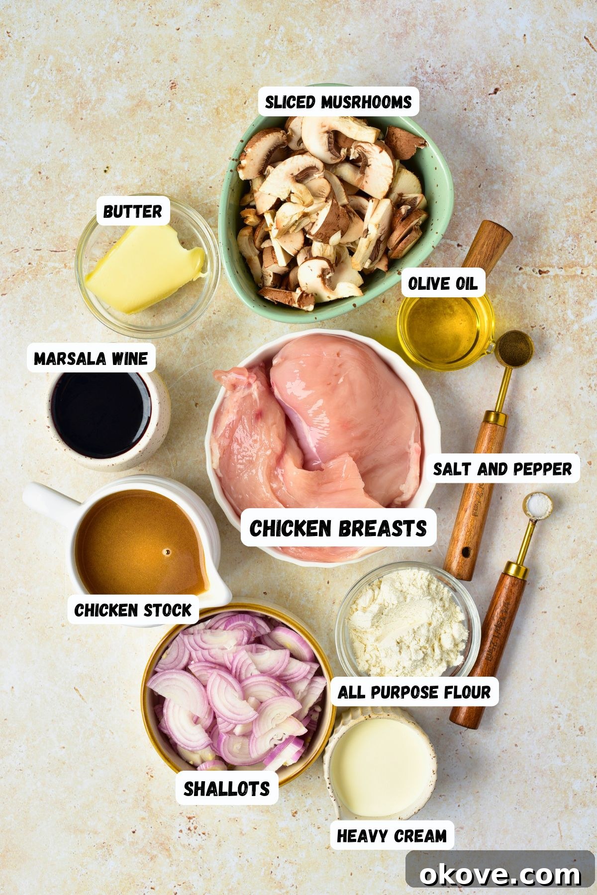 Ingredients measured into small bowls and labeled, on a marble table.