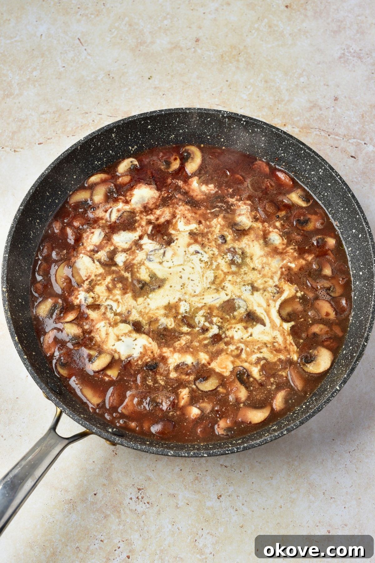 Heavy cream being added to skillet to make sauce thick and creamy.