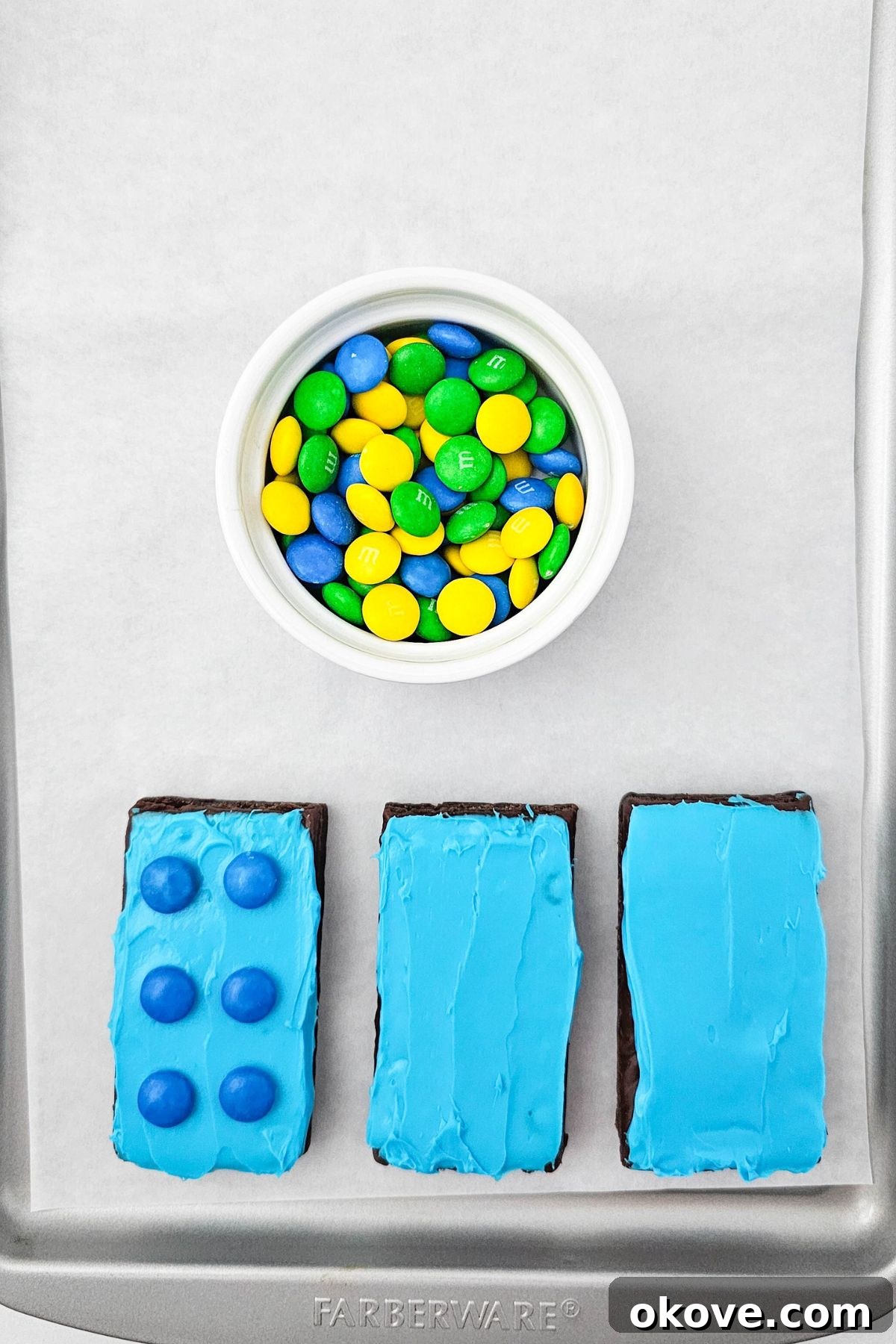 Frosted brownies topped with matching chocolate candies, perfectly arranged to look like Lego bricks.