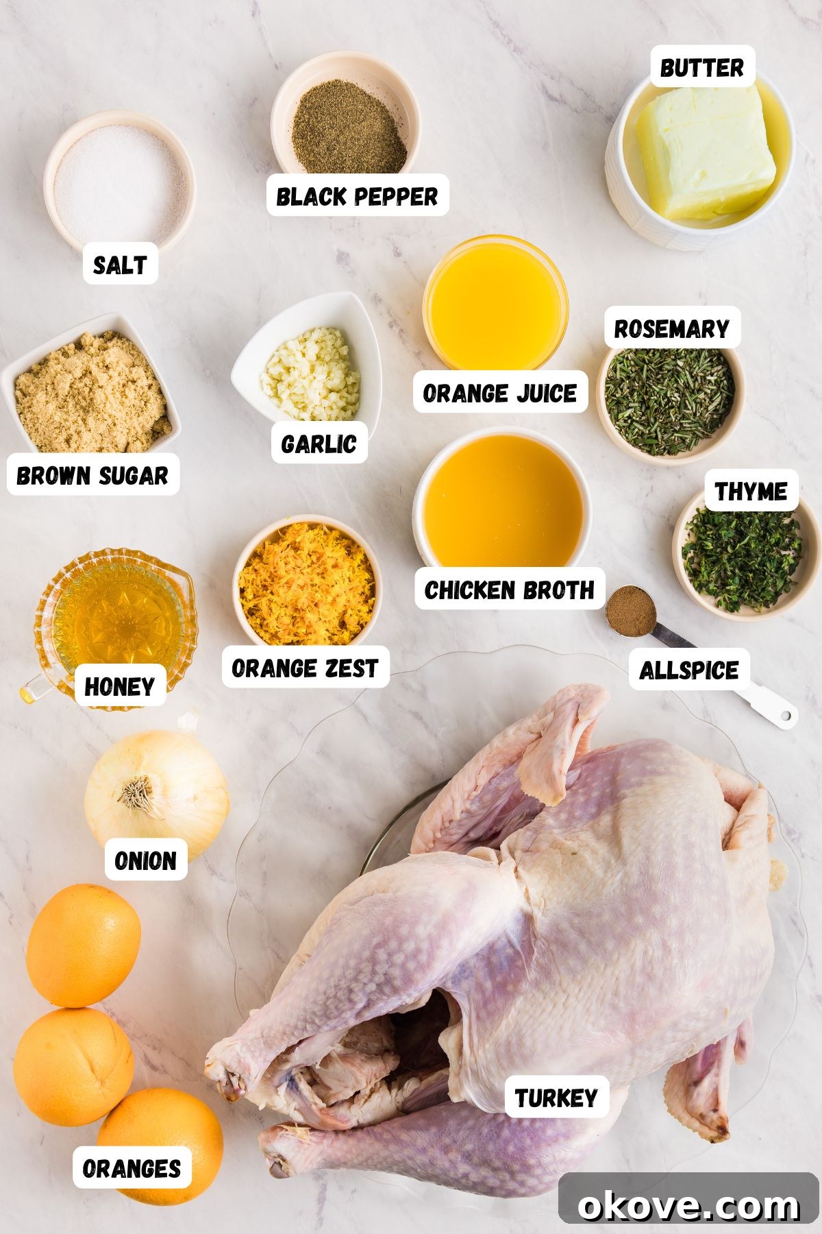 Golden Roasted Turkey Perfection 3 Ingredients to make roasted turkey measured into small bowls and labeled, on a white marble table, along with an uncooked turkey.