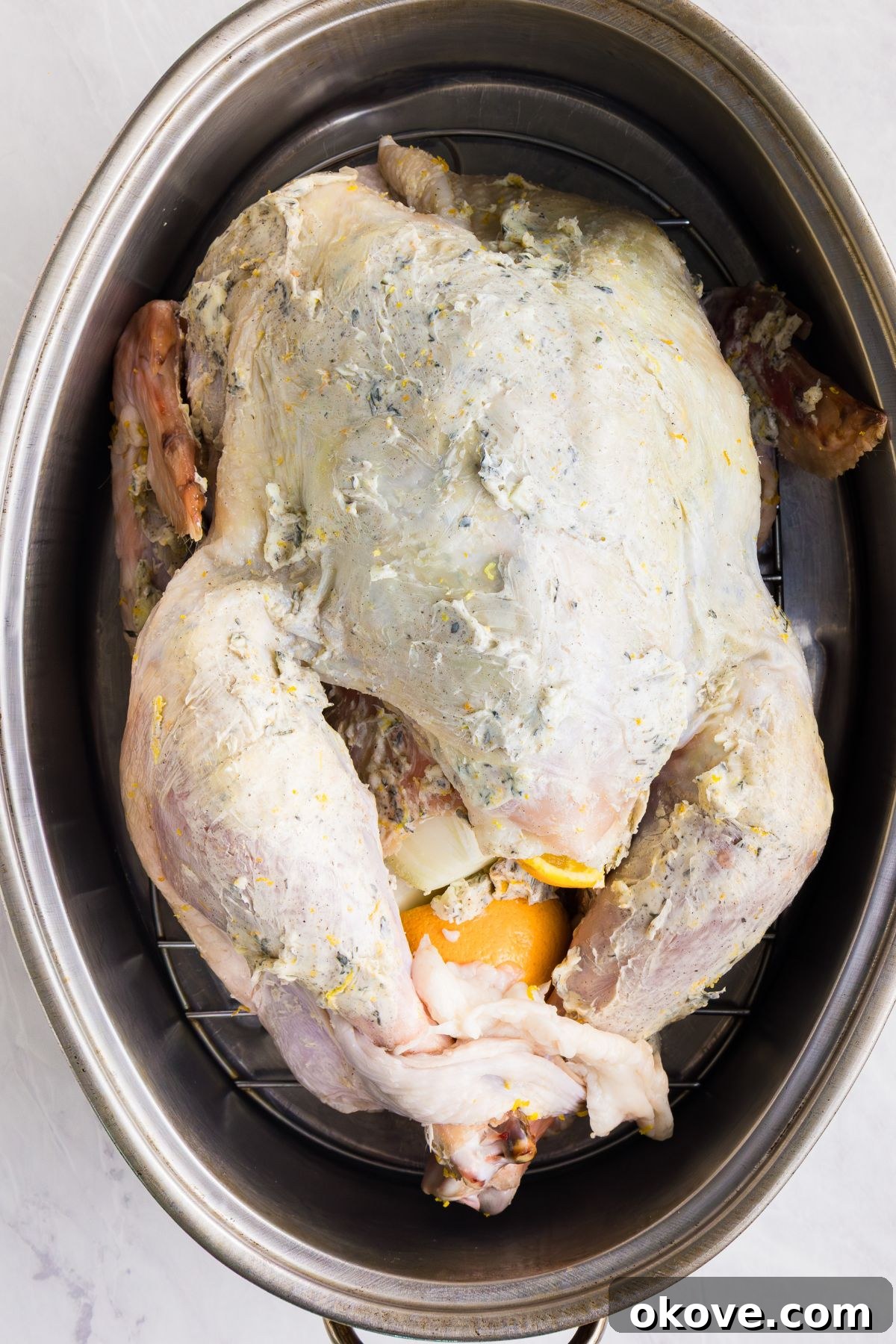 Golden Roasted Turkey Perfection 8 Whole uncooked turkey, seasoned, in a large roasting pan.