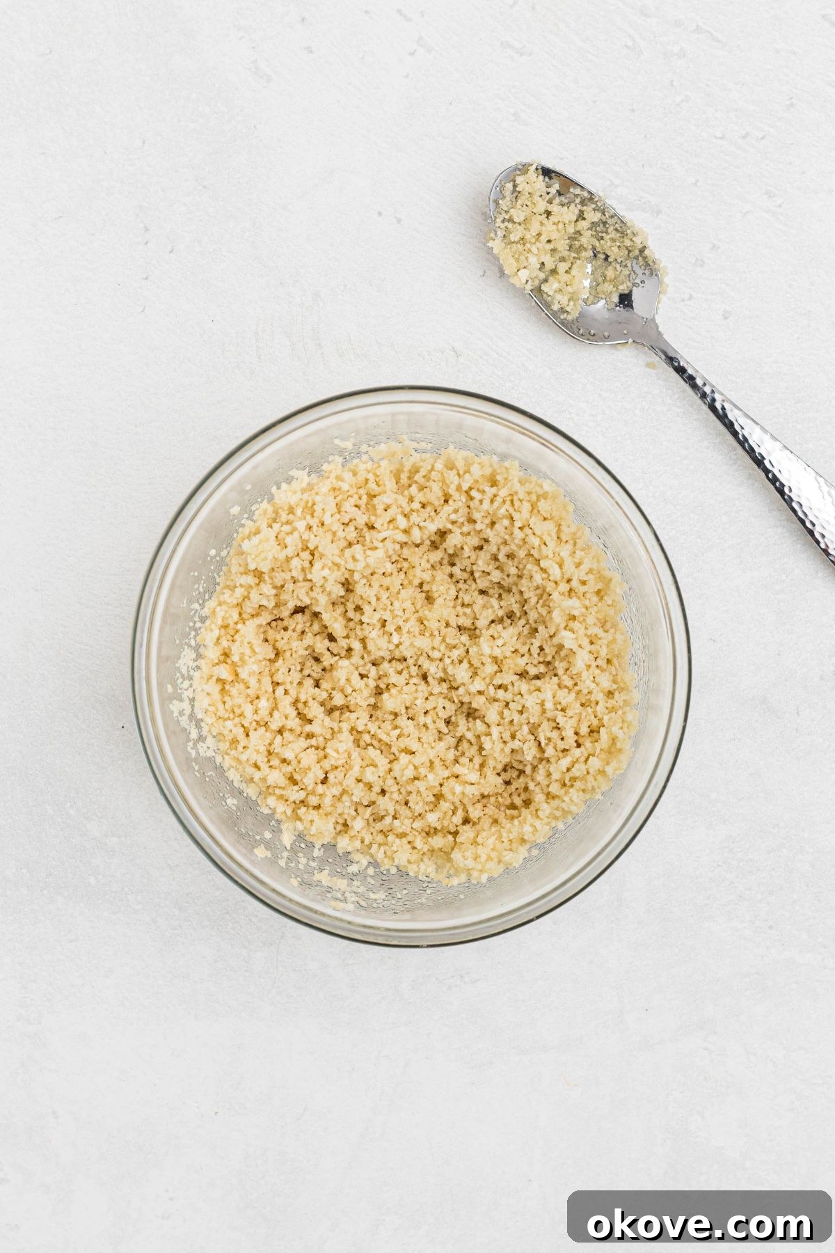 Ultimate Smoked Macaroni and Cheese Bake 8 Panko bread crumbs and melted butter being mixed together in a medium glass bowl.