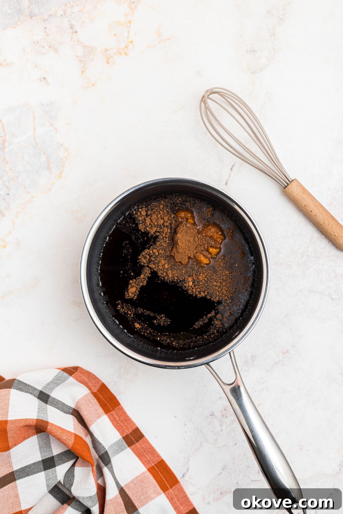 Golden Autumn Elixir 5 Cinnamon and pumpkin being mixed into brown sugar and water in a small saucepan.