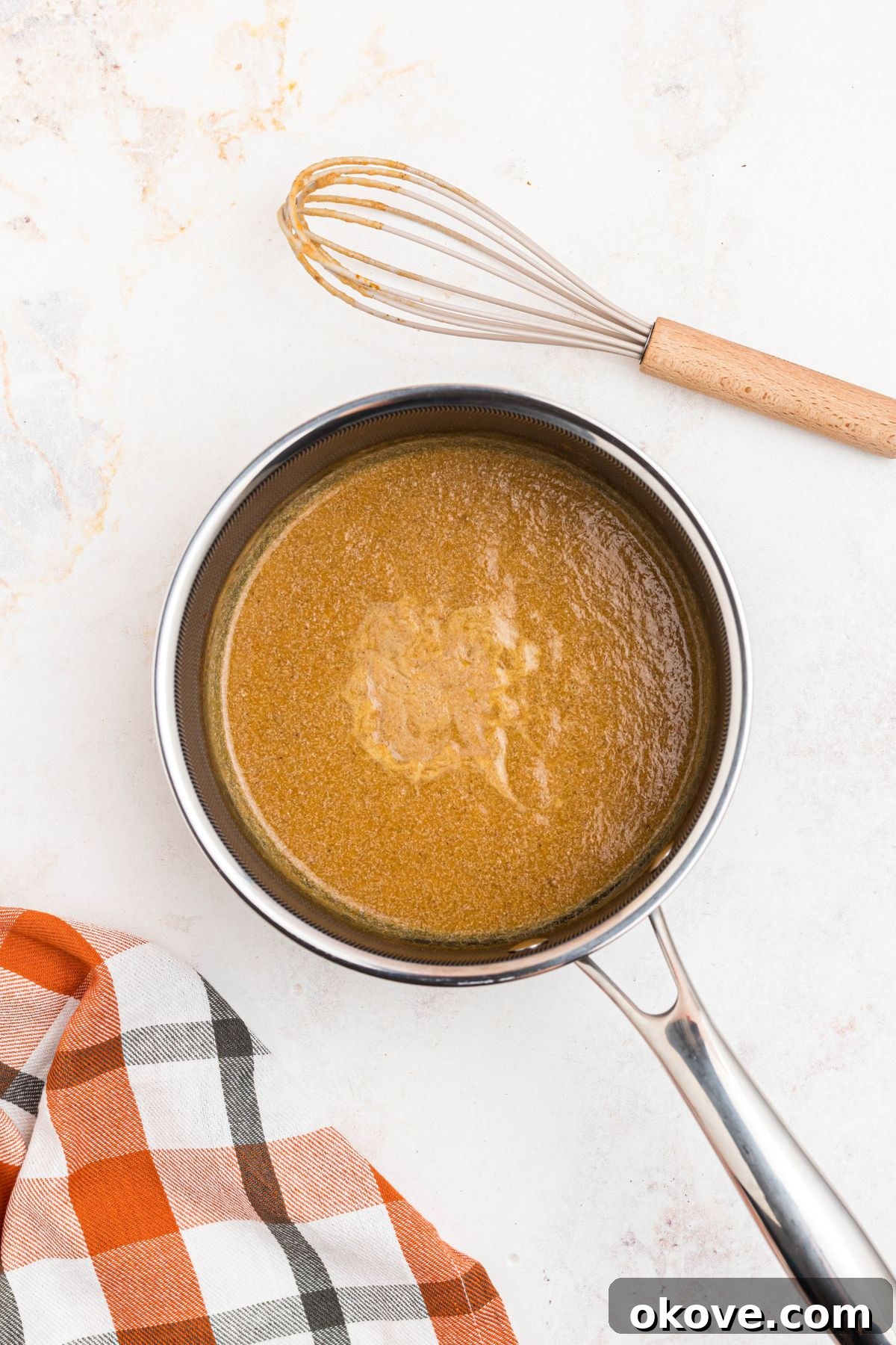 Cozy Pumpkin Spice Brew 5 Pumpkin and spice mixture lightly simmering in a small saucepan, creating a fragrant base for the coffee.