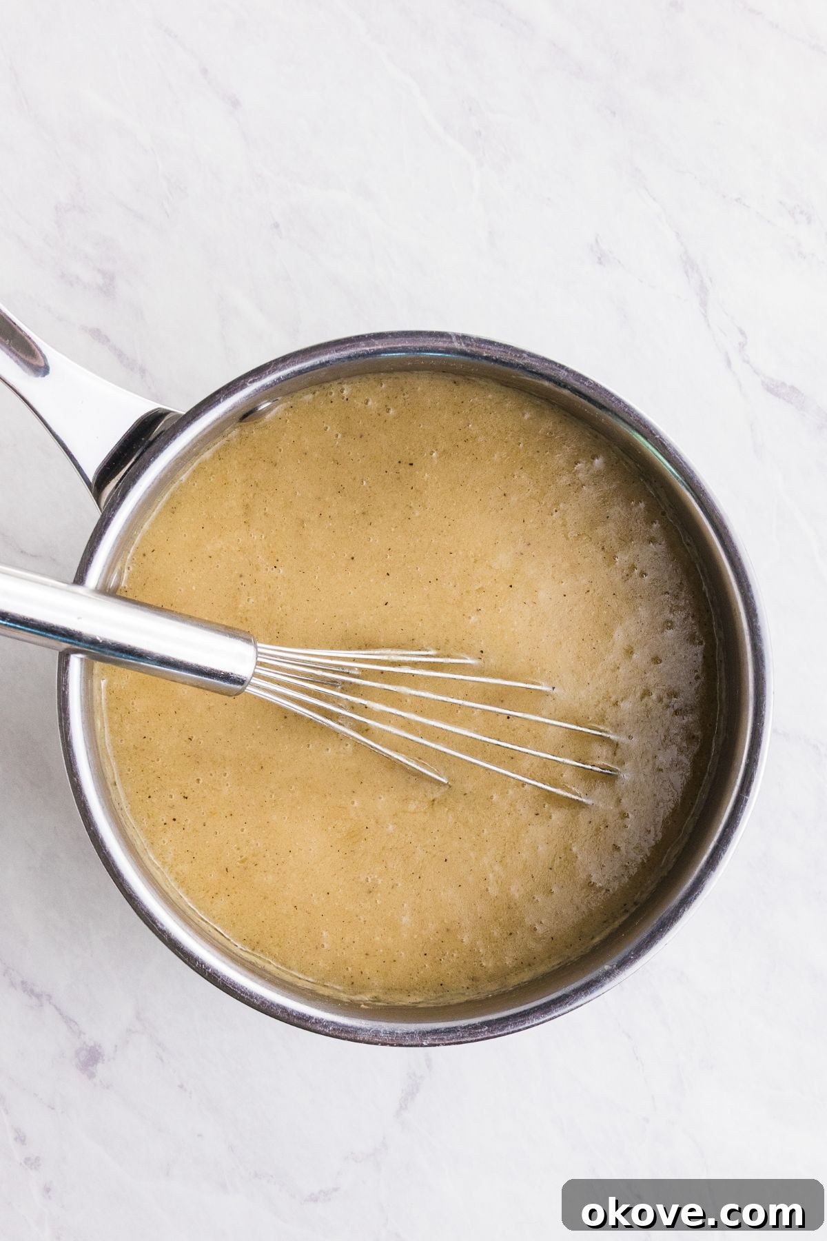 From Pan Drippings to Perfection 5 Flour and seasonings, mixed with melted butter and broth to make homemade gravy, in a large saucepan.