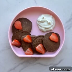 Delicious chocolate spinach pancakes topped with berries