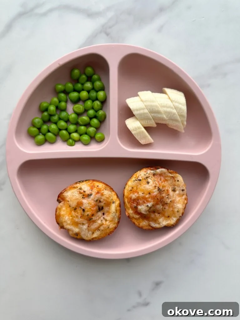 Deep Dish Pizza Cups 2 Two deep dish mini pizzas on a divided plate with sliced banana and peas.
