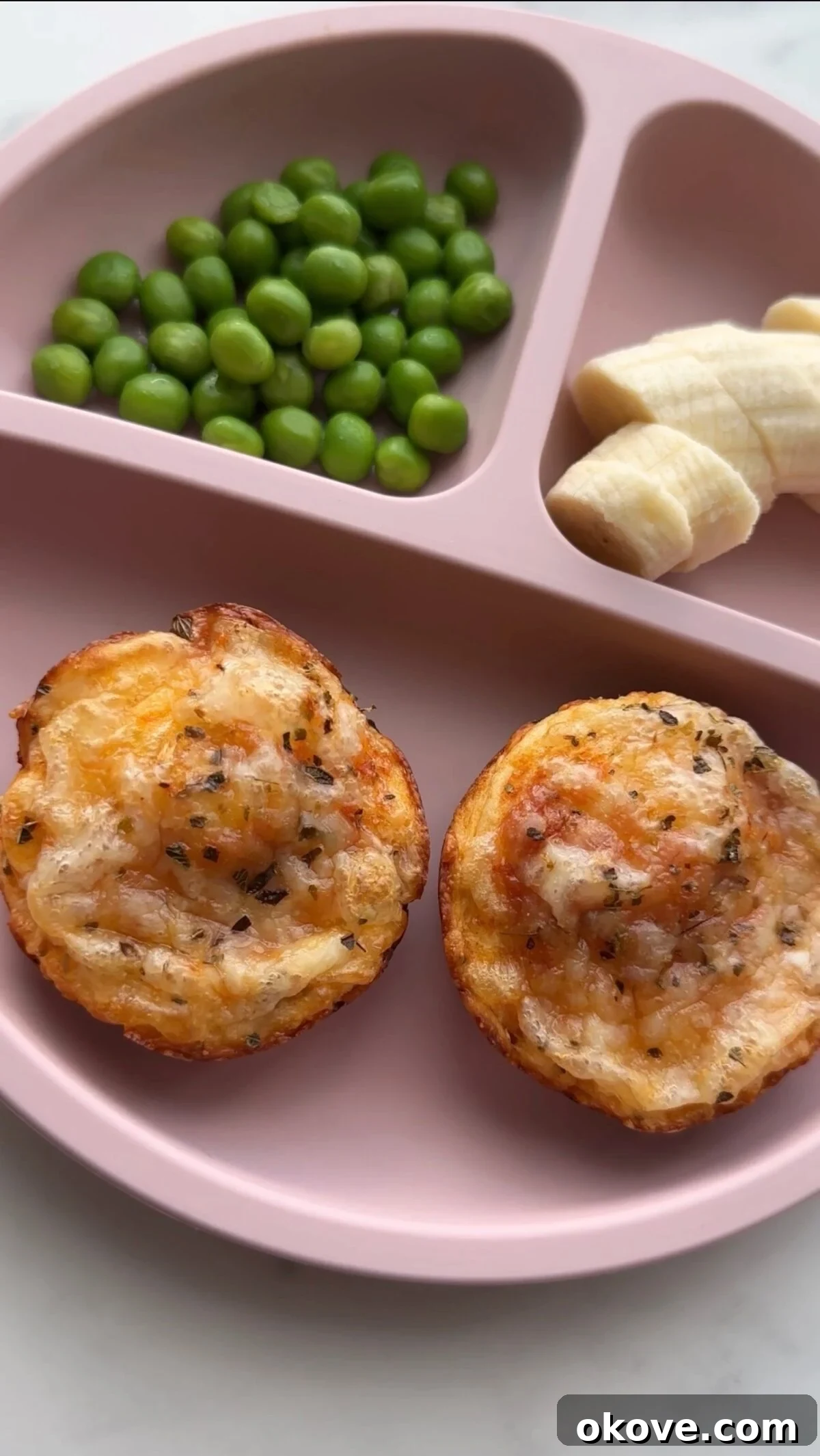 Deep Dish Pizza Cups 3 Two deep dish mini pizzas on a divided plate with sliced banana and peas.