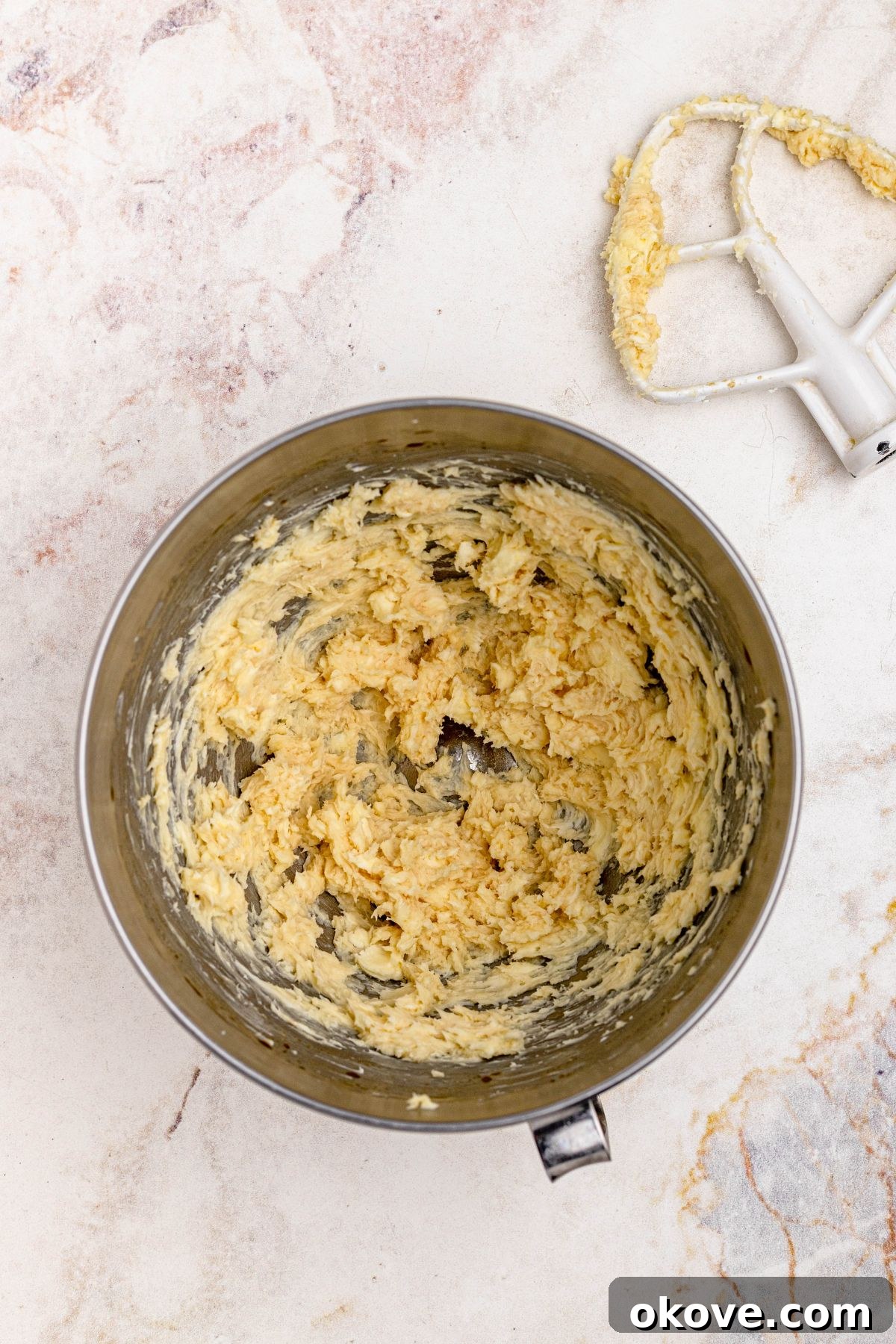 Powdered Cloud Kisses 4 Butter and sugar, creamed together in a silver mixing bowl for snowball cookies.