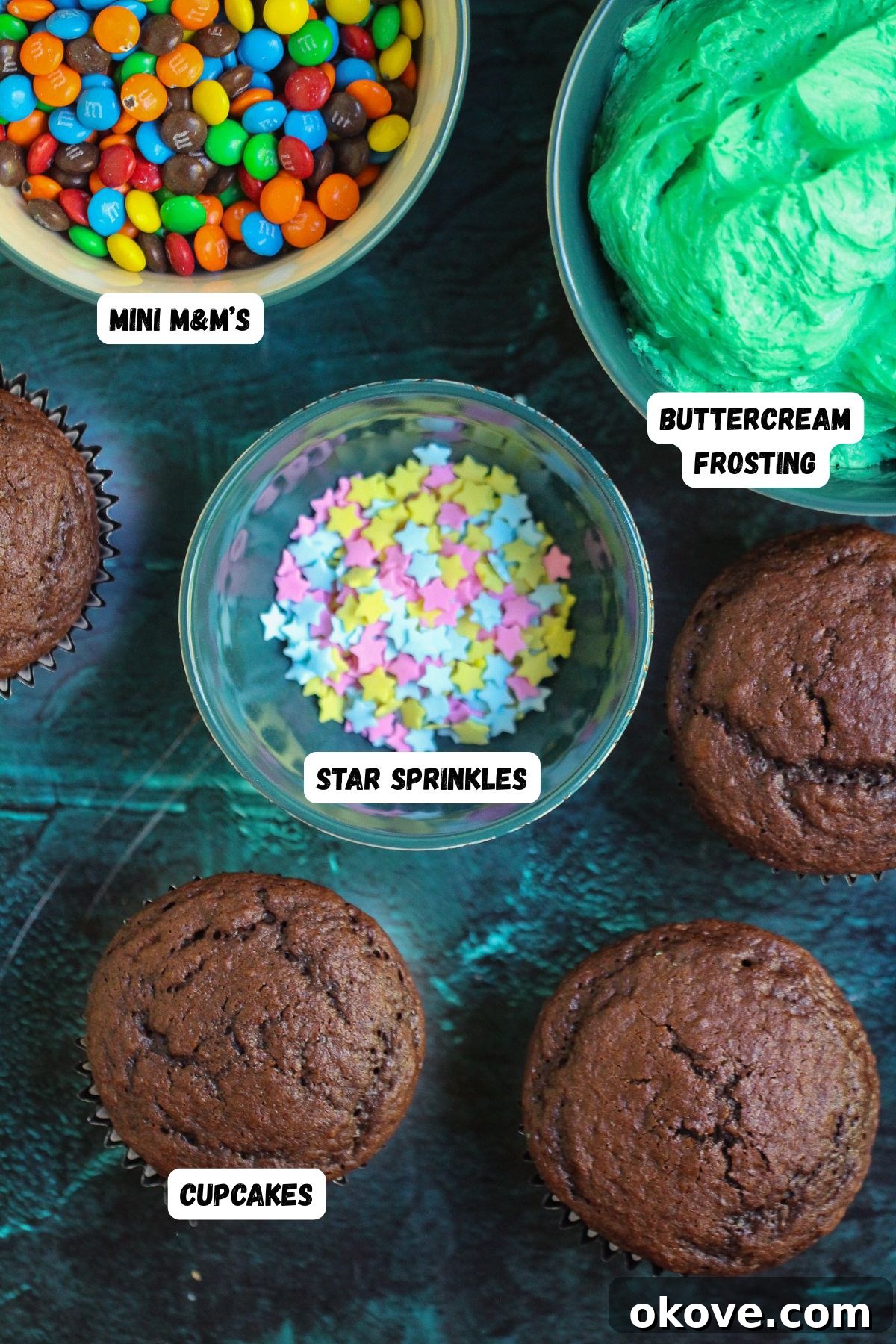 Edible Christmas Trees 3 Ingredients of cupcakes, sprinkles, and frosting on a marble table, and labeled in photo.