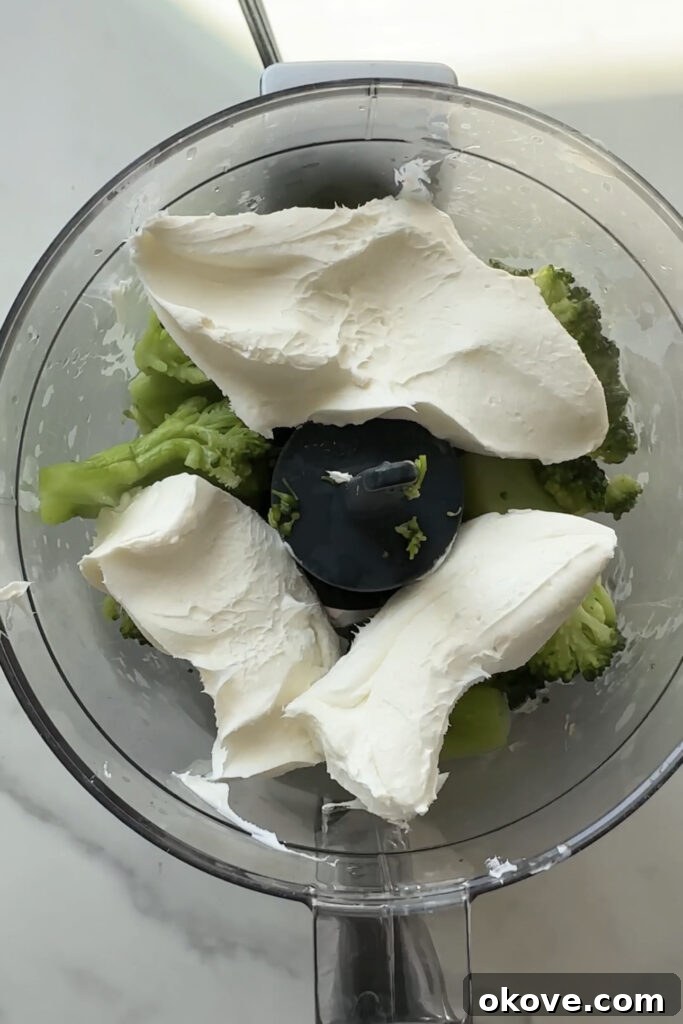 Creamy Broccoli Pasta 4 Broccoli pasta sauce blending in a food processor, creating a smooth, creamy texture.