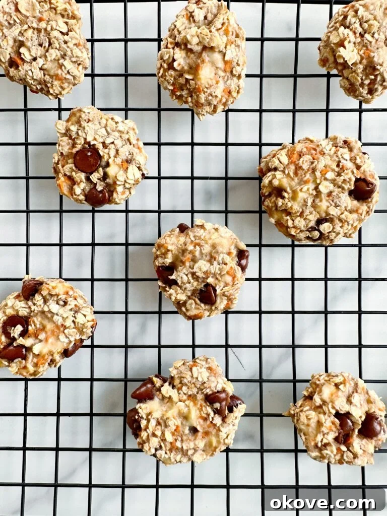 Golden Carrot Banana Oat Delights 2 Several soft banana carrot oat cookies neatly arranged on a cooling rack, ready to be enjoyed.