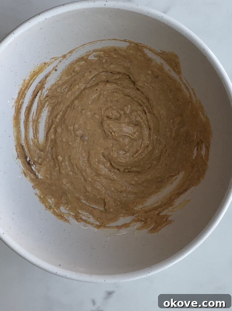 Healthy sweet potato muffin ingredients mixed in a bowl