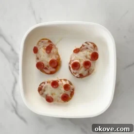 Three mini pizzas on a white plate