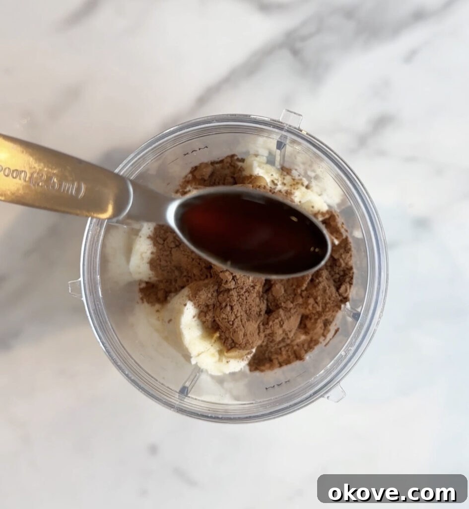 Guilt-Free Fudge Pops 7 A measuring spoon with vanilla extract, a crucial flavor enhancer for homemade fudgesicles.