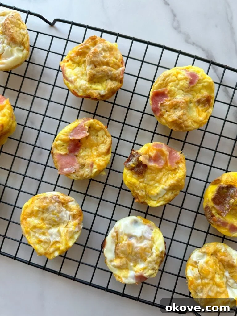 Morning Muffin Bites 2 Several golden brown breakfast cups cooling on a wire rack, ready to be enjoyed