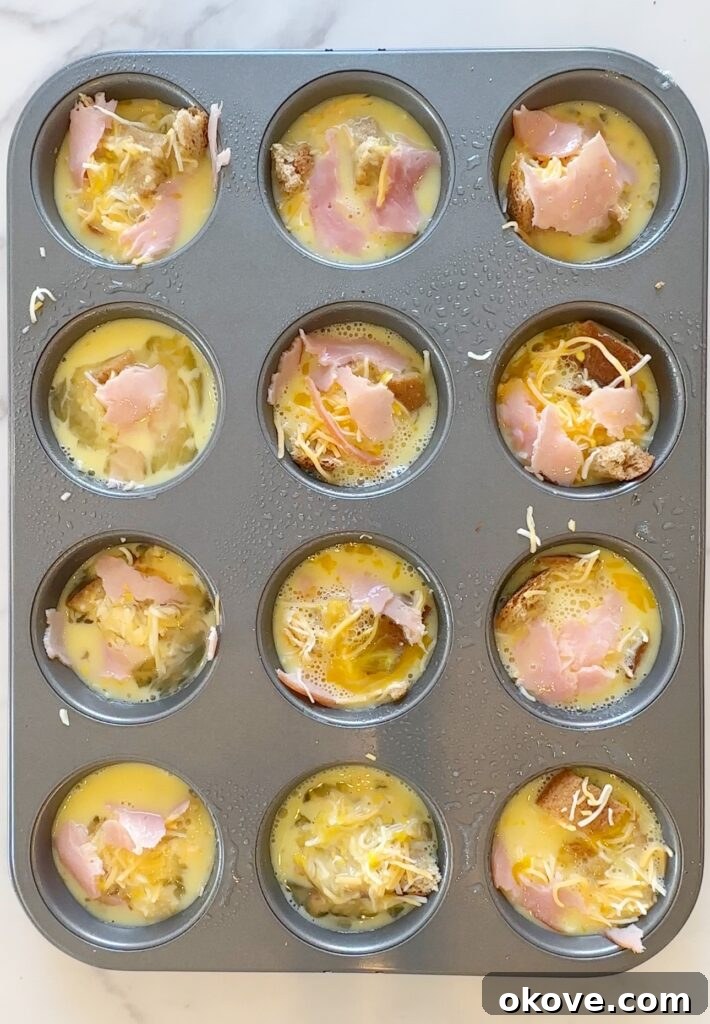 Morning Muffin Bites 6 Uncooked breakfast cups in a muffin tin, filled with egg mixture and ready for baking