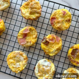 A perfectly cooked breakfast cup with ham, cheese, and a bread base