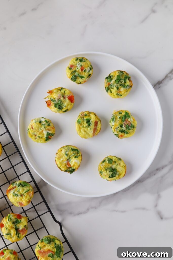 Several spinach egg bites on a white plate