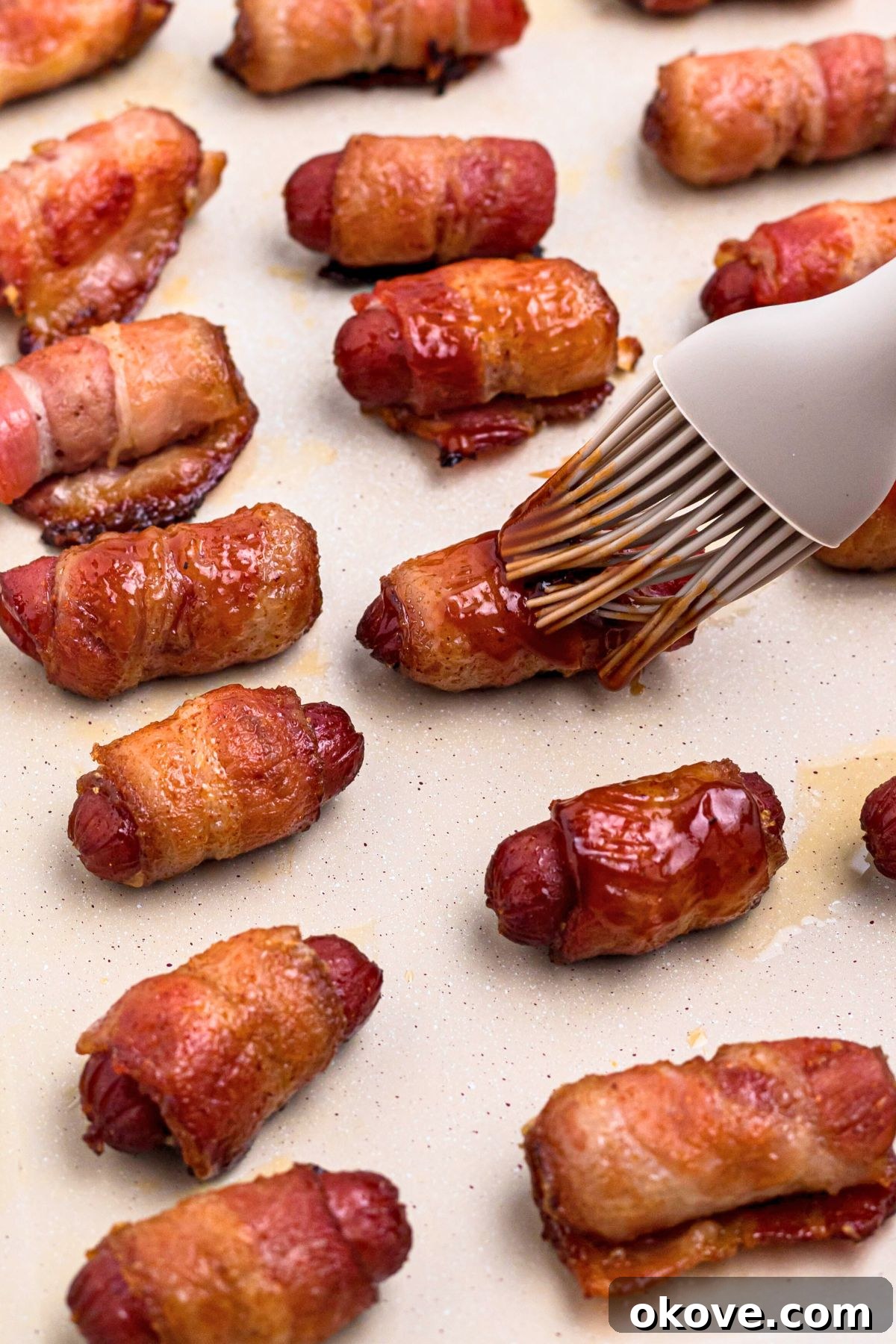 Bacon wrapped cooked smokies, brushed with bbq sauce.