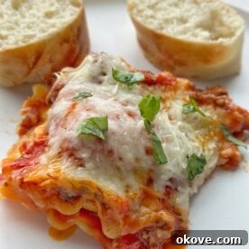 A top-down view of the freshly baked Ravioli Lasagna, showing the golden-brown cheese topping and bubbling sauce.