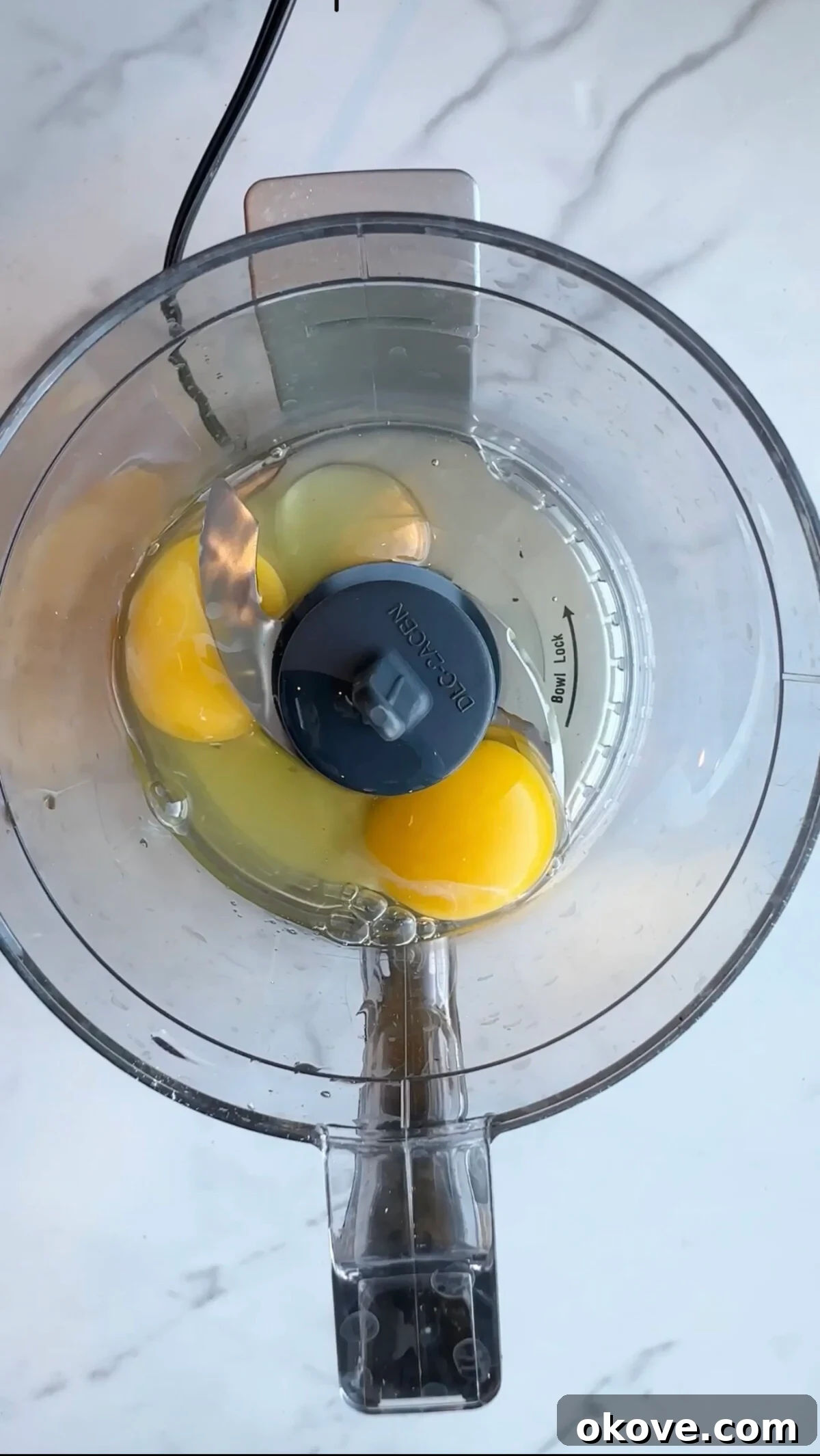 Fresh spinach and eggs in a blender, ready to be processed into a vibrant green mixture.