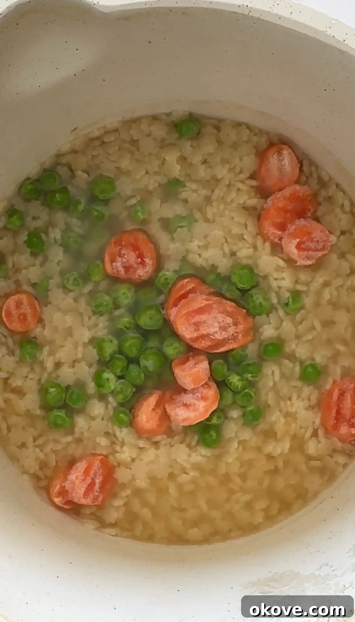 Uncooked chicken noodle soup ingredients assembled in a bowl, ready to be cooked for a toddler-friendly meal.