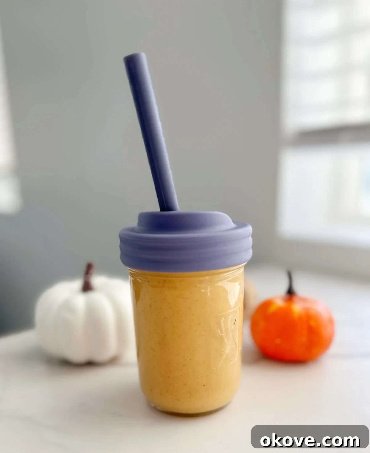 Pumpkin Spice Velvet 2 Vibrant creamy pumpkin smoothie in a tall glass, garnished with a sprinkle of cinnamon, perfect for a healthy fall breakfast or toddler snack.