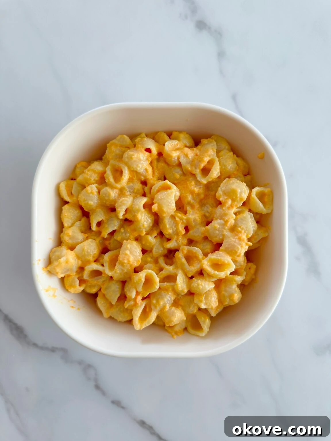 Creamy carrot pasta in a white dish