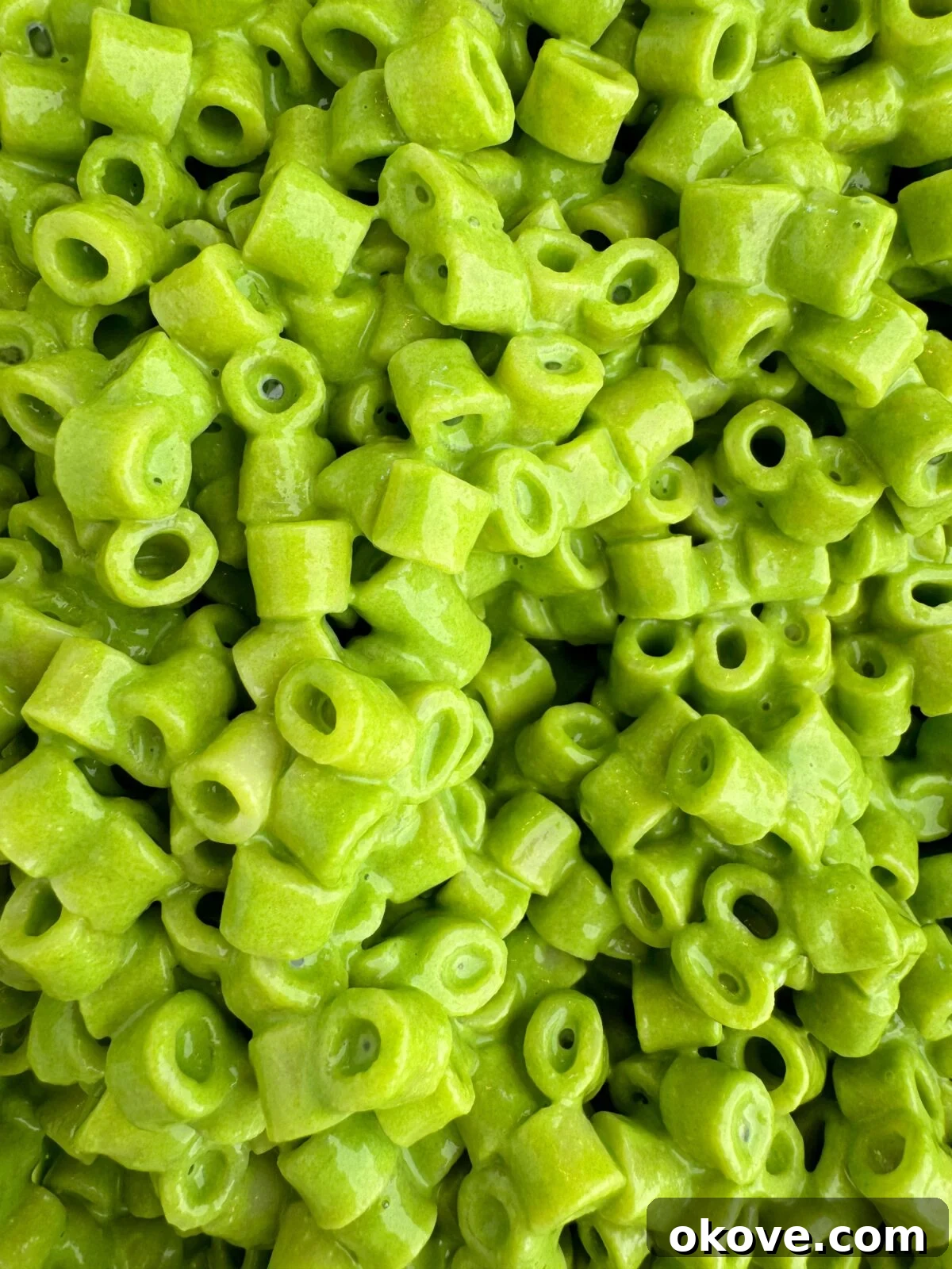 Velvet Spinach Pasta 3 A vibrant close-up of creamy spinach pasta with a rich green sauce, showcasing the smooth texture, on a white plate.