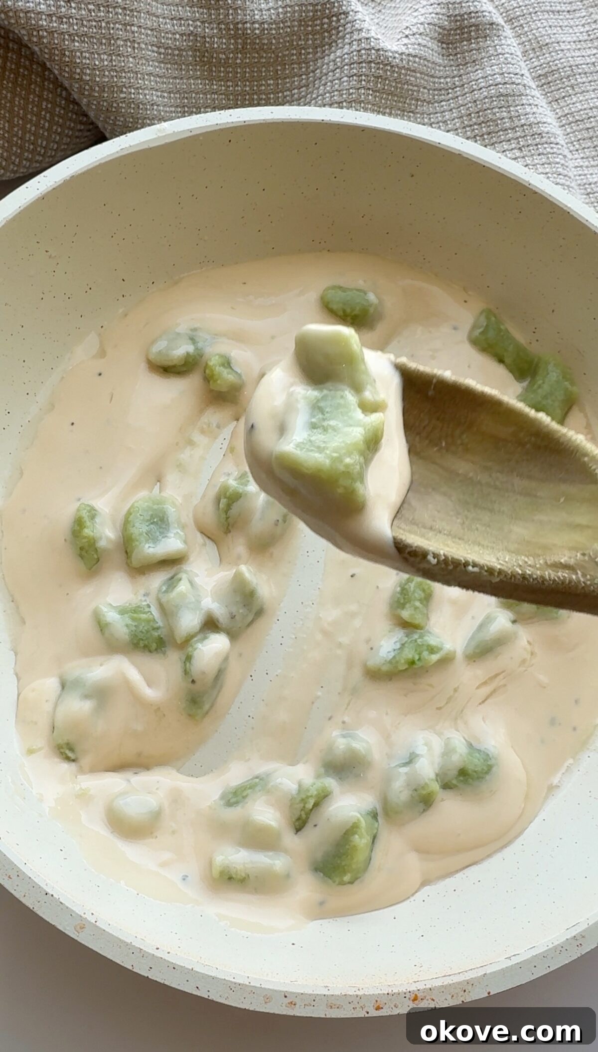 Emerald Avocado Pasta 4 Close-up of freshly made avocadough pasta with a light sauce and garnish.