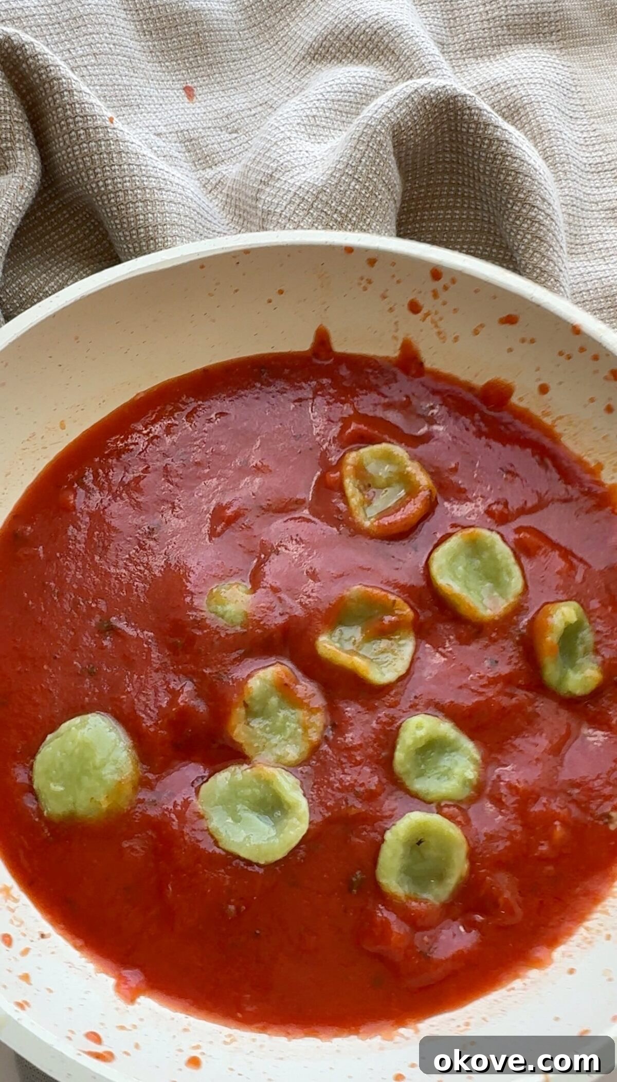 Emerald Avocado Pasta 6 Avocadough pasta in a red sauce, demonstrating its versatility with different flavors.