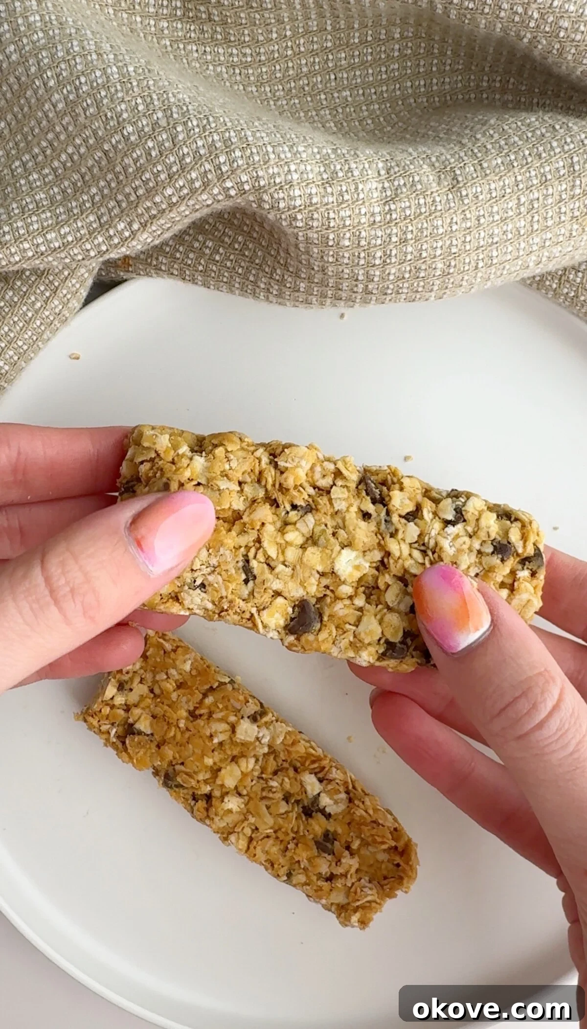 Wholesome Homemade Granola Bars 2 Two easy homemade granola bars on a white plate
