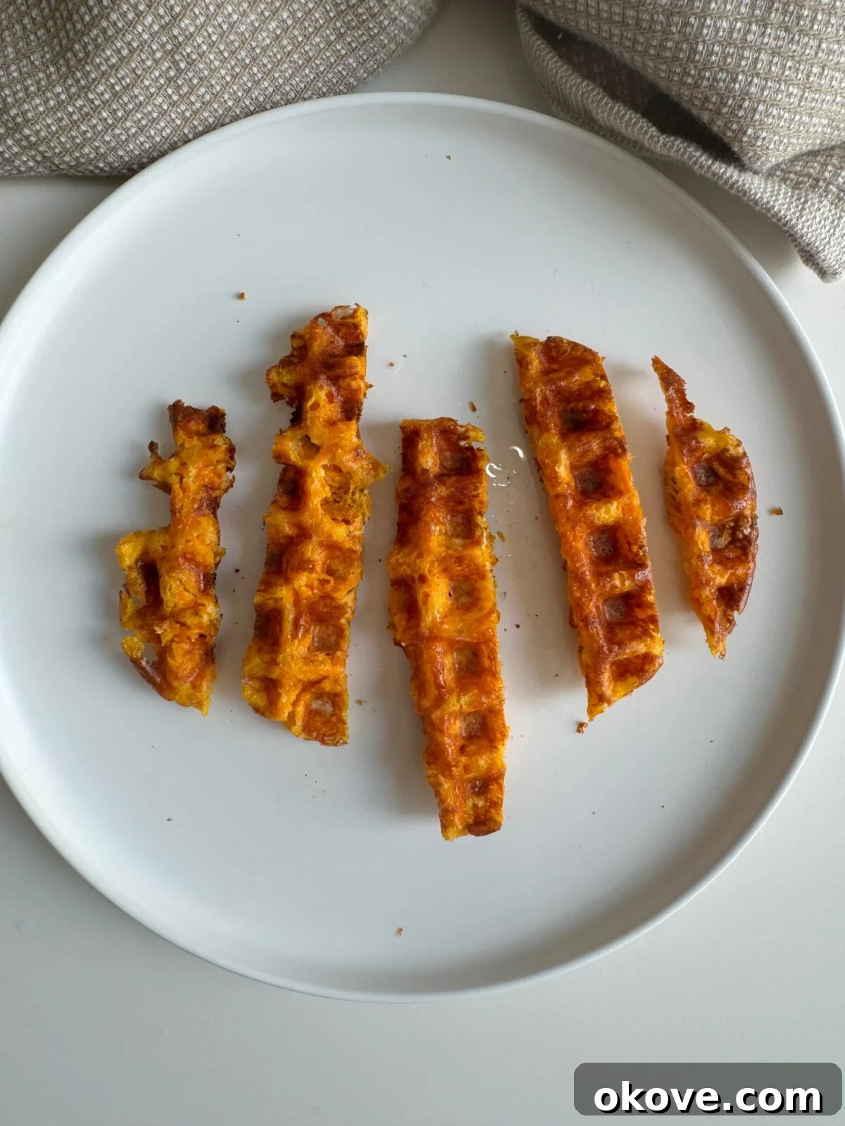 Cheesy carrot waffles cut into strips