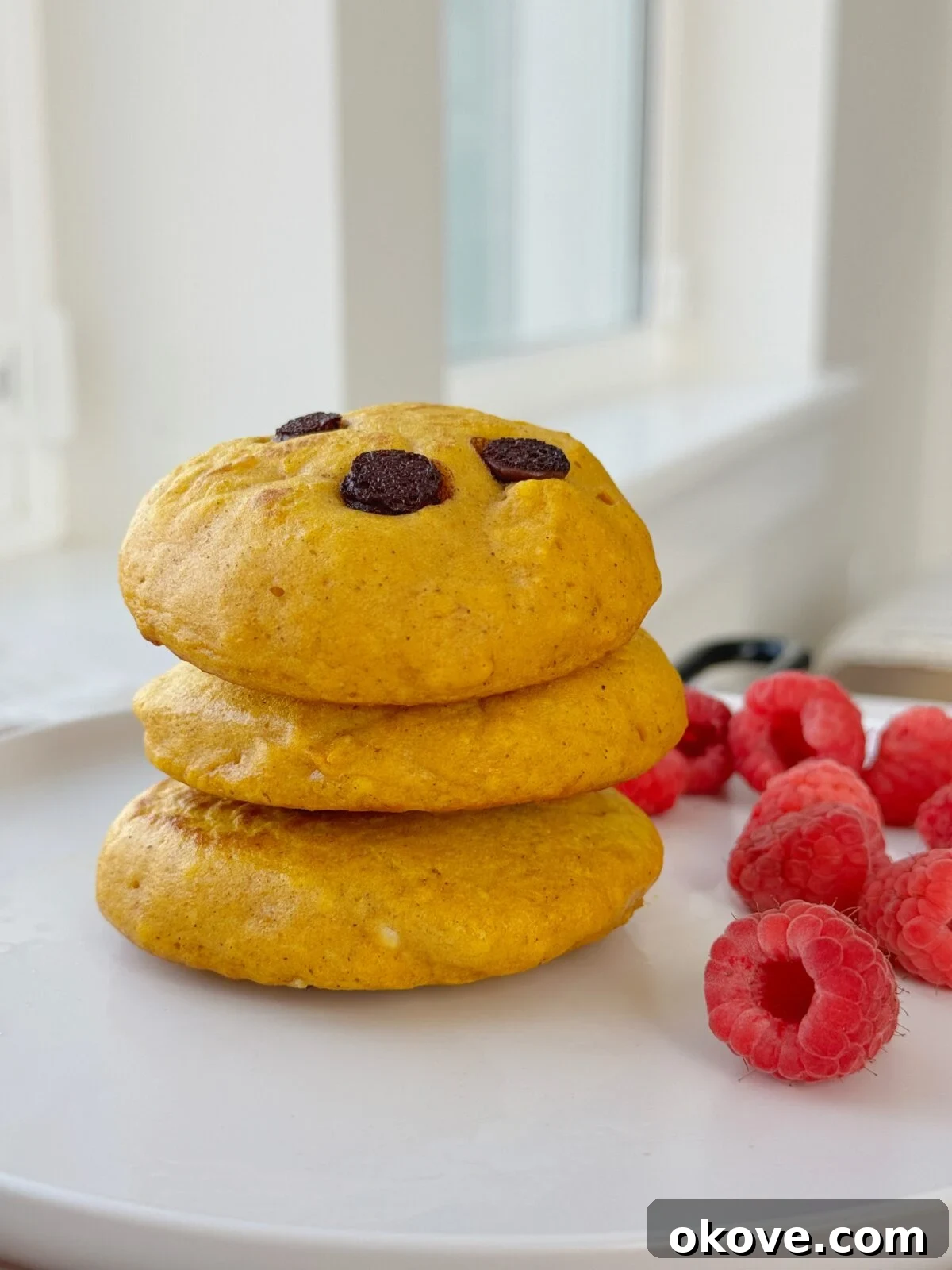 Three pumpkin pancakes stacked on top of each other